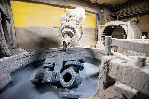 robotics dipping a lost wax ceramic mol in a vat of slurry